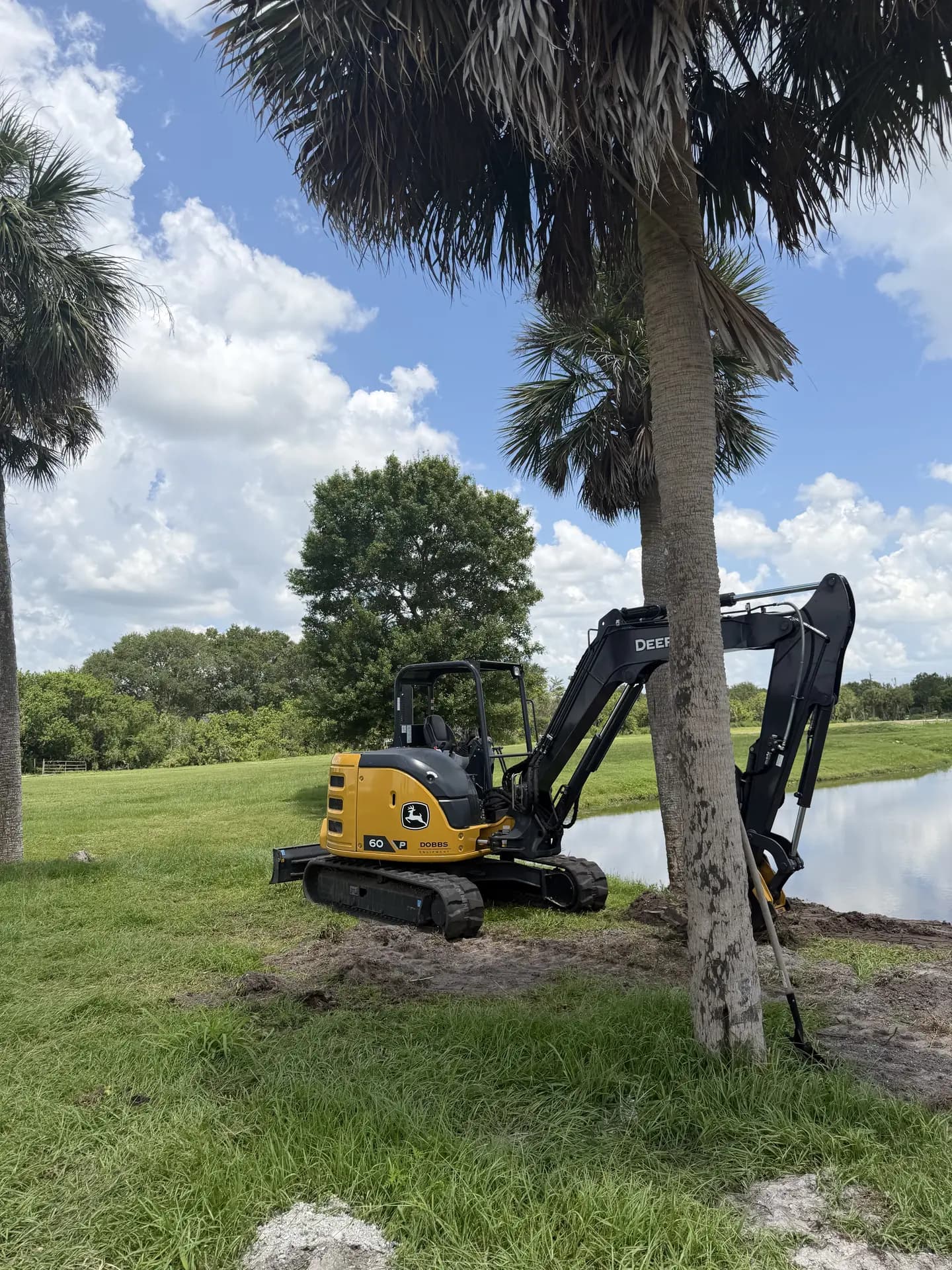 Excavator completing land enhancement work beside a Central Florida wetland
